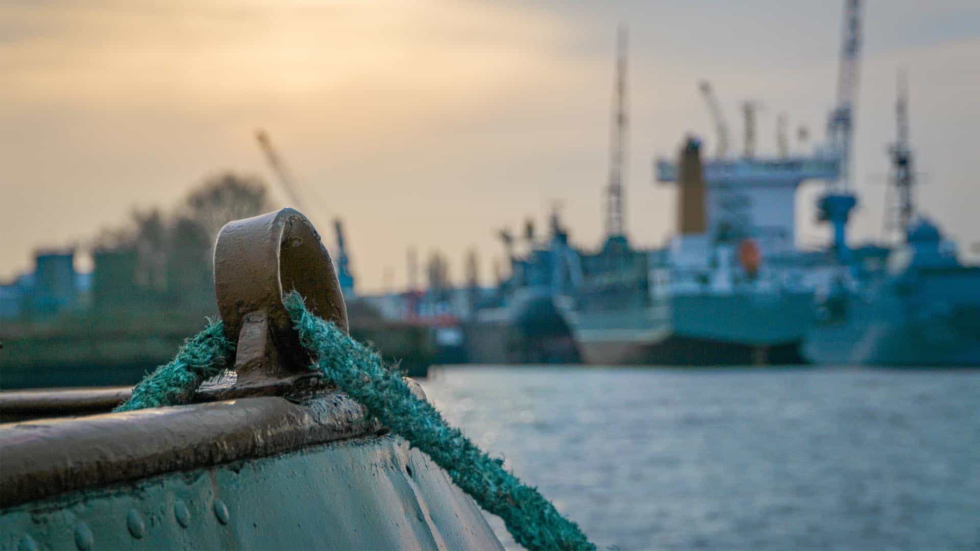 Close up of a rope tied at a port.