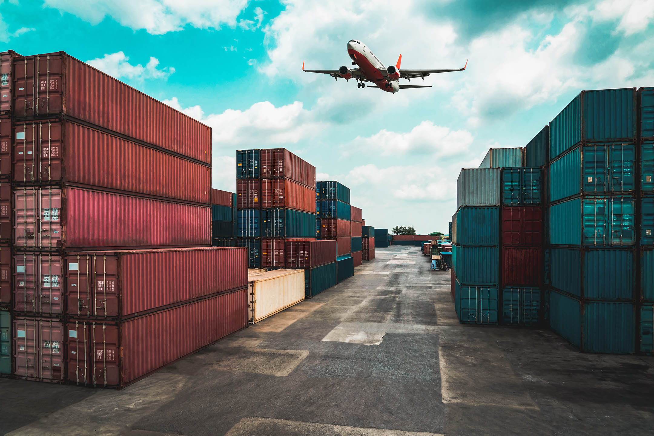 Plane flying over a storage containers