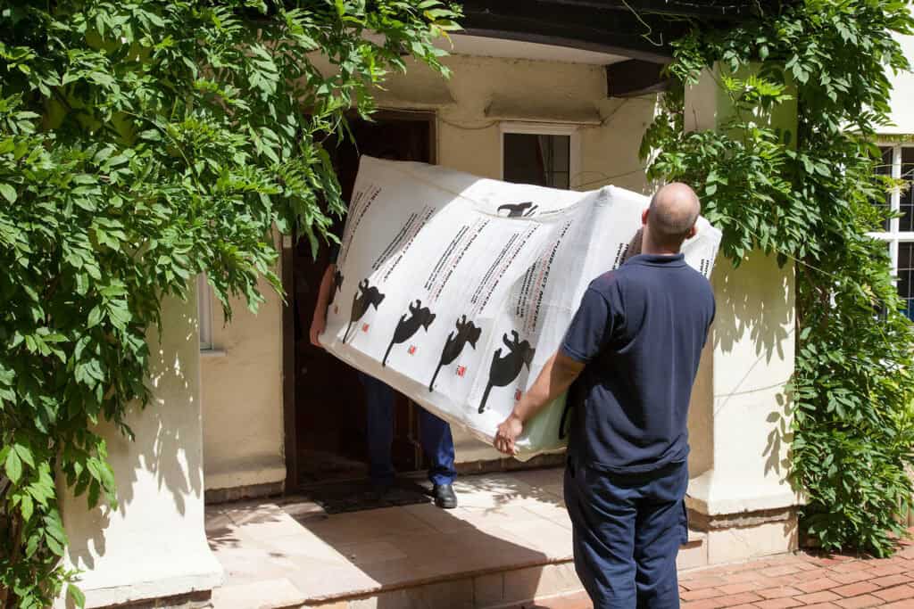 Doree Bonner staff moving a DBI branded box into a property