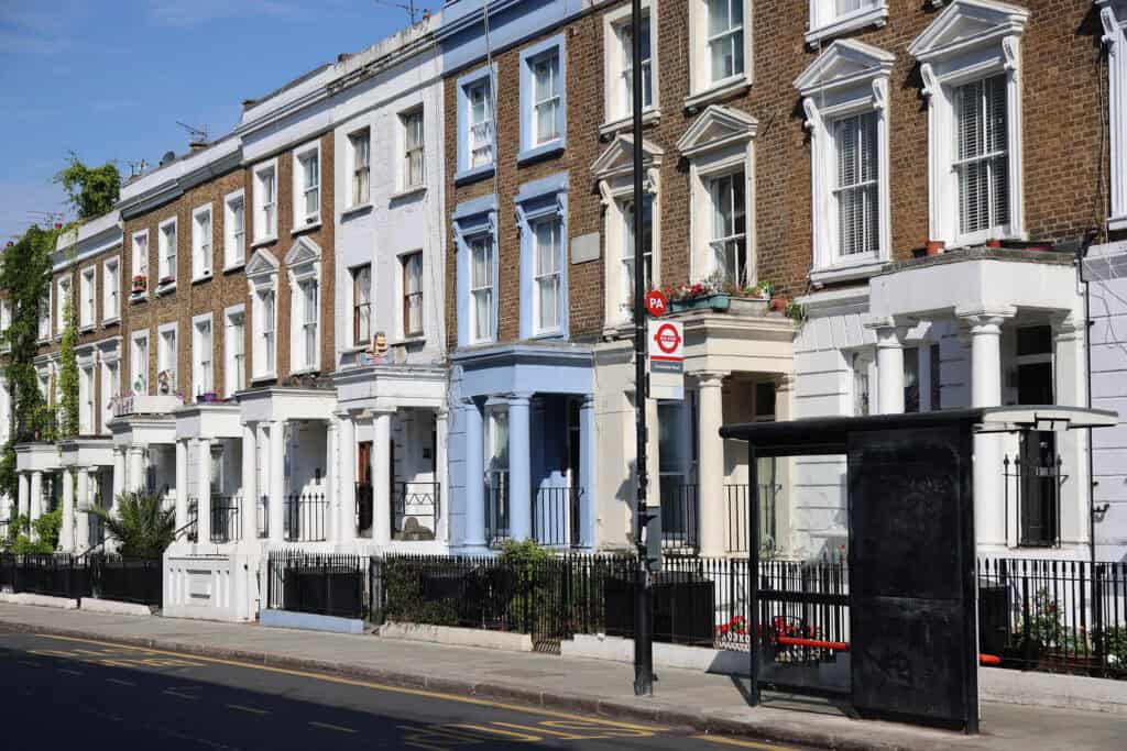 Row of London homes with a bus stop just outside.